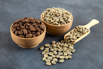 Green coffee with roasted coffee beans on gray background