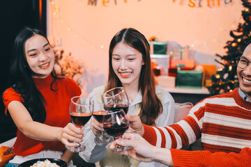 Friends opening Christmas gifts in living room