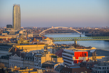 Bratislava city view with bridges spanning the Danube River and urban buildings.