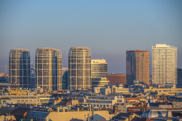 Modern high-rise buildings in Bratislava illuminated by golden hour sunlight.