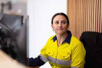 Female worker sitting in front of the computer in an office.