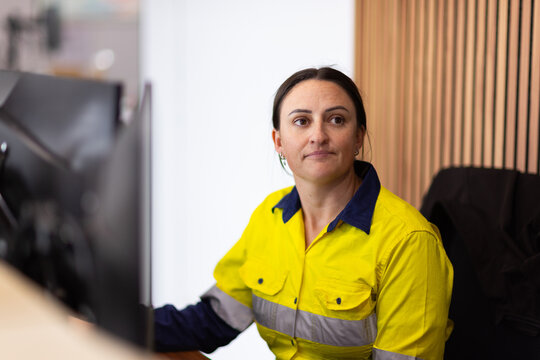 Female worker sitting in front of the computer in an office.