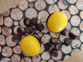 Yellow Lemons, almonds and shiny brown chestnuts on the table	