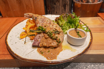 Grilled pork chop with curry fried onion and pepper sauce