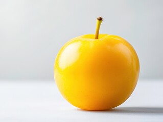 Detailed view of a yellow plum with glossy surface.