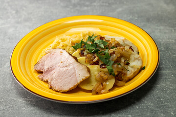 pork meat with potato dumplings and pickled cabbage served with roasted onion