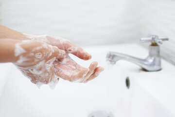 Hygiene. Cleaning Hands. Washing hands with soap under the faucet with water