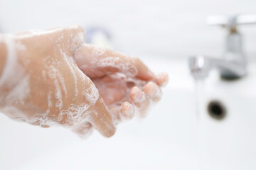 Fototapeta premium Hygiene. Cleaning Hands. Washing hands with soap under the faucet with water