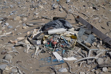 spread out trash on a sand beach