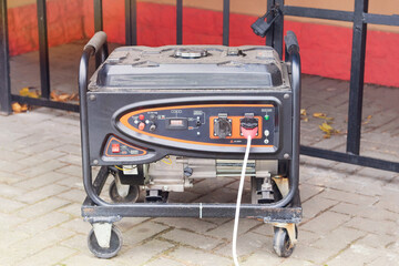 Portable gasoline or diesel generator to provide electricity in city. Problem with electricity. Blackout.