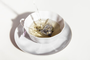 Brewing a tea bag with boiling water in a tea pair