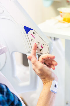 Hands of a patient in hospital using buttons on side of bed