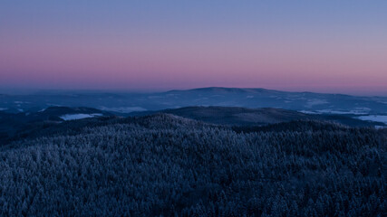 Colorful sunset over the Czech countryside. View from Mount Žaltman - the highest mountain in the Jestrebí Mountains.