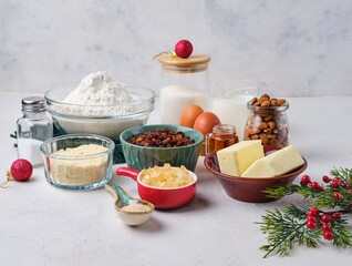 Prepared ingredients for making Christmas baking on white concrete background. Stollen or Christmas cake.