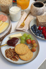 Assortment of various breakfast foods and drinks on the white table. Selective focus.