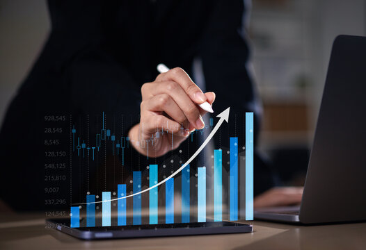 Businessman drawing virtual technical graphs and charts to analyze stock market. Business and technology stock chart data. Stock trading and investment concept. Forex trading analysis.