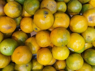 Several oranges for sale at a market in Bangkok, Thailand.