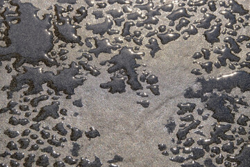 Abstract shapes, patterns and textures of water droplets on the floor.Copy space for graphic design. Background Natural patterns and textures. Wet floor surface