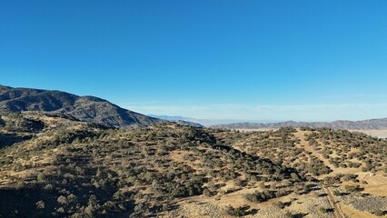 Scenic view of rolling hills under a clear blue sky.