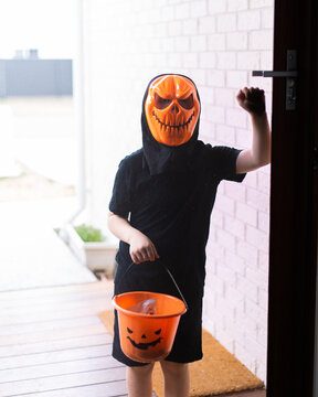 masked child trick or treating on halloween