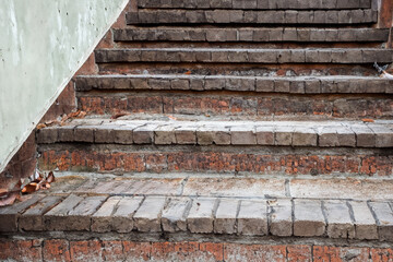 Stairs in the old brick building. Close up of a brick staircase up. Brick stairs close up red. A red brick staircase with red stairs up lifestyle.