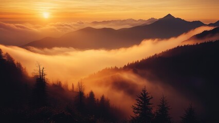 Obraz premium A serene sunrise scene with a mountain range shrouded in mist and fog filling the valley below