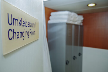 Male locker changing room with lockers, towel rack, sink and amenities inside spa thermal suite...