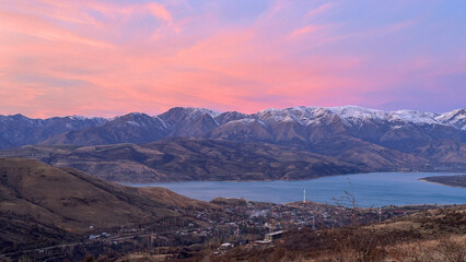 Snowy peaks mountains at the sunset