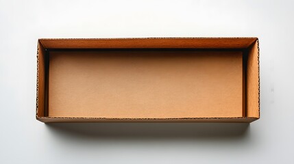A brown corrugated cardboard box photographed from above, showing clean interior and minimal packaging details with soft shadows in professional studio lighting.