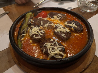 Turkish Kofte or Kofta Meatballs with cheese on a tile plate.