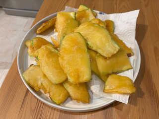Breaded Fried Zucchini Snacks on wooden table.