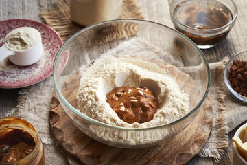 Whey protein powder, peanut butter, raw cacao and soaked dates - prepration of homemade protein chocolate bars