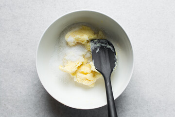 Top view of Creaming butter and sugar with a spatula, the process of making a cake or cookie