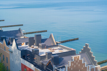 Roof of a house on the embankment during construction.The back side of the facade of an unfinished building against the backdrop of the sea.Construction of real estate in a recreation and tourism area