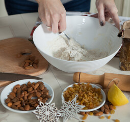 hands of a woman preparing biscuits or cakes in the kitchen