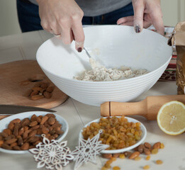 hands of a woman preparing biscuits or cakes in the kitchen