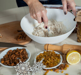 hands of a woman preparing biscuits or cakes in the kitchen