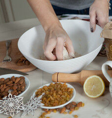 hands of a woman preparing biscuits or cakes in the kitchen