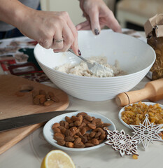 hands of a woman preparing biscuits or cakes in the kitchen