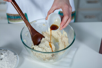 hands of a woman preparing biscuits or cakes in the kitchen