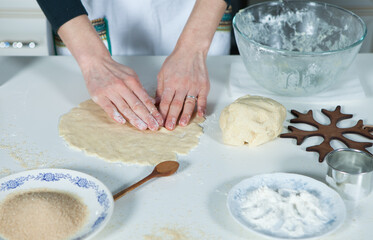 hands of a woman preparing biscuits or cakes in the kitchen