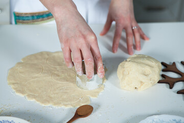 hands of a woman preparing biscuits or cakes in the kitchen