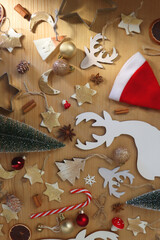Various Christmas decorations in neutral colors on wooden background. Flat lay.