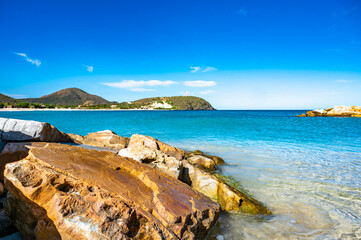 rocky shoreline with a body of water in the background