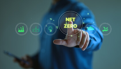 Net-zero and carbon-neutral concept. Businessman touch on virtual screen Net Zero icons, renewable energy, co2 emissions reduction, green production, waste recycling, solar power.