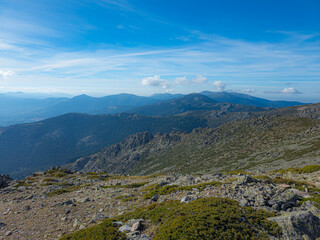 Panoramic view of the Sierra de Guadarrama with clear skies. On the horizon, the iconic weather radar atop the summit is visible.