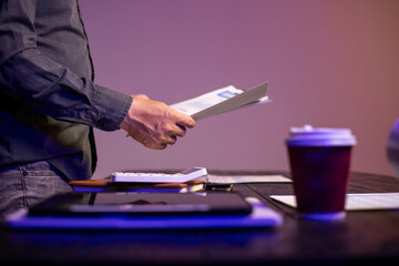 Accountants working on financial investments on calculators, calculating, analyzing business and marketing growth on graphs of various financial documents.
