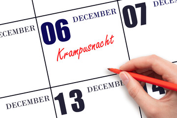 December 6. Hand writing text Krampusnacht on calendar date. Save the date.