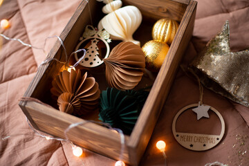 wooden box with Christmas toys. A wooden box with Christmas tree toys, shining balls, a gift box