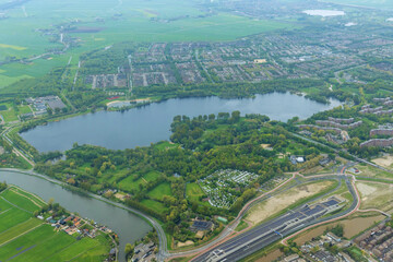City Amsterdam at Netherlands from an aerial view in cloudy weather is composed panorama of over rooftops